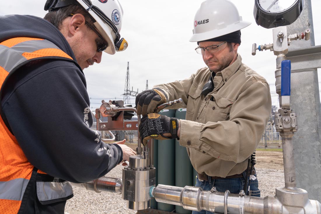 NAES technicians adjusting hydrogen fuel blending system components