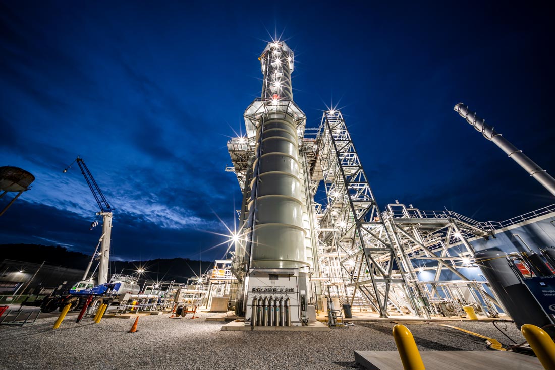 Power plant operations – looking north – showing continuous emissions monitoring equipment enclosure at the base of the stack