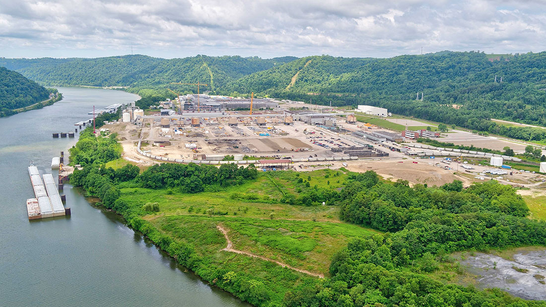 Site overview during power plant construction, looking east