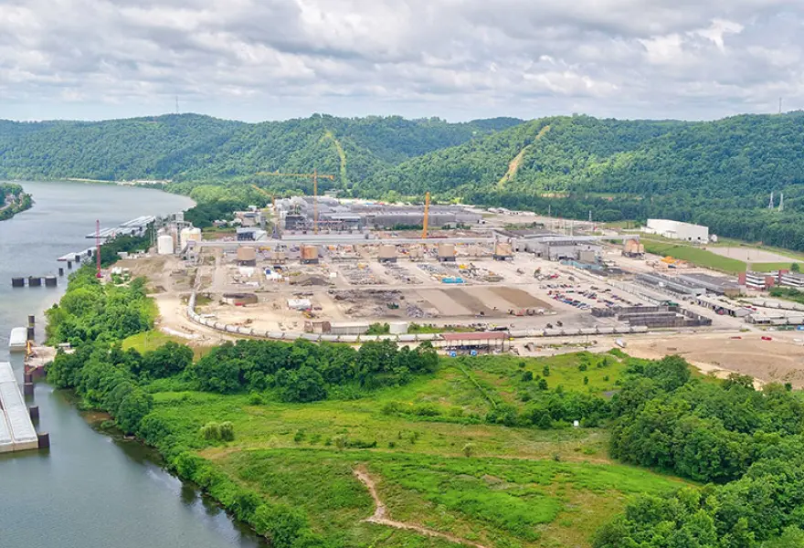 Site overview during power plant construction, looking east