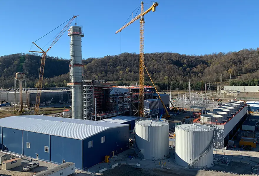 Power plant construction – placing top section of exhaust stack at 223 feet above site elevation