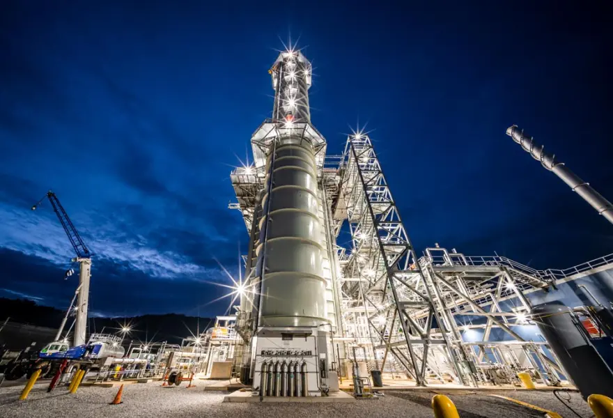 Power plant operations – looking north – showing continuous emissions monitoring equipment enclosure at the base of the stack